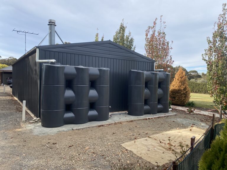 Installation of two slimline water tanks.